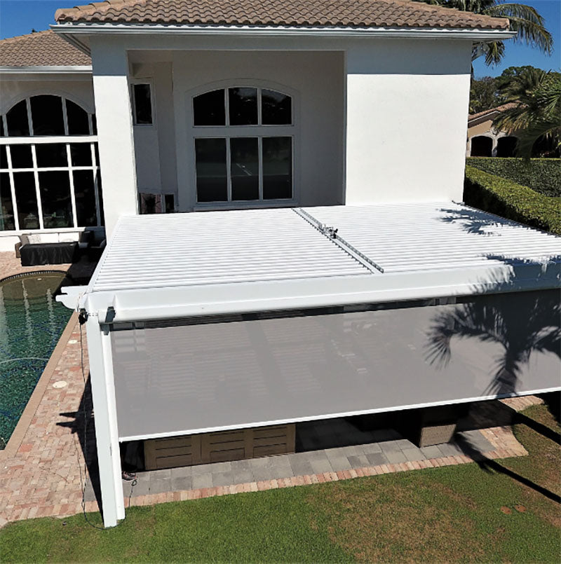 A motorized screen housing mounted along the head of an exterior opening.