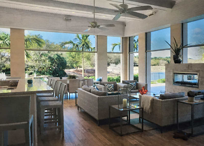 Covered outdoor kitchen and seating area with screens across the openings.