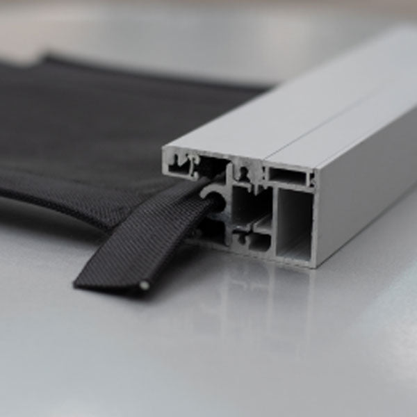 Close-up of the aluminum side track of a motorized exterior screen, with the screen edge running into it.